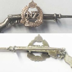 SH025. GOLD NZ ONWARD BADGE ON SILVER RIFLE.